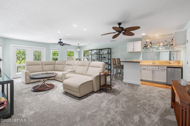 143 Istoria Dr, Saint Augustine, FL 32095 - living room with ceiling fan, carpet, a textured ceiling, bar area, and recessed lighting