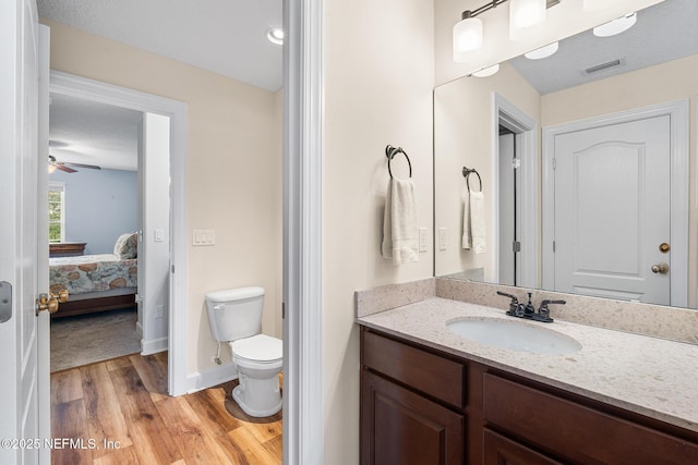 143 Istoria Dr, Saint Augustine, FL 32095 - bathroom with vanity, wood finished floors, toilet, baseboards, and ensuite bathroom