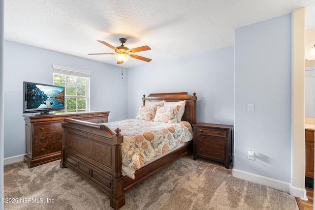 143 Istoria Dr, Saint Augustine, FL 32095 - carpeted bedroom with baseboards, a ceiling fan, ensuite bathroom, and a textured ceiling