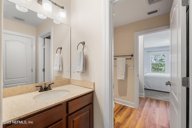 143 Istoria Dr, Saint Augustine, FL 32095 - ensuite bathroom featuring wood finished floors, vanity, and baseboards