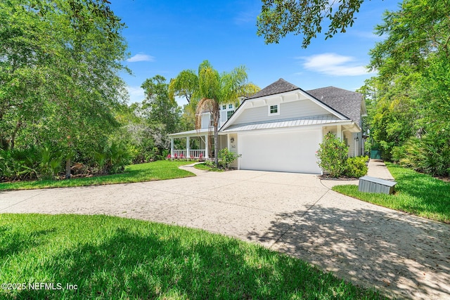 143 Istoria Dr, Saint Augustine, FL 32095 - view of front of property with driveway, a front yard, a garage, covered porch, and roof with shingles