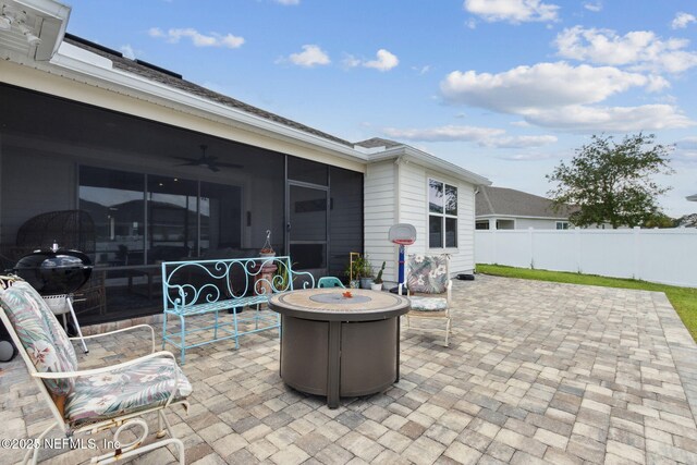 94001 Goodwood Dr, Fernandina Beach, FL 32034 - view of patio / terrace with a fire pit, a ceiling fan, and a sunroom
