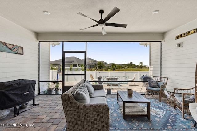 94001 Goodwood Dr, Fernandina Beach, FL 32034 - living room featuring wood walls, ceiling fan, a textured ceiling, and brick floors