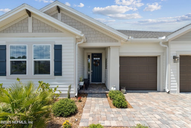94001 Goodwood Dr, Fernandina Beach, FL 32034 - doorway to property with a garage, driveway, and a shingled roof