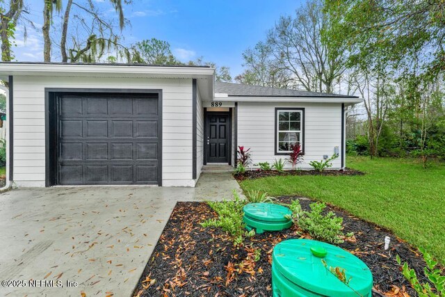 889 Aiken St, Saint Augustine, FL 32084 - ranch-style house with a front yard, driveway, and a garage