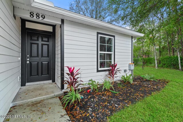 889 Aiken St, Saint Augustine, FL 32084 - doorway to property featuring a yard