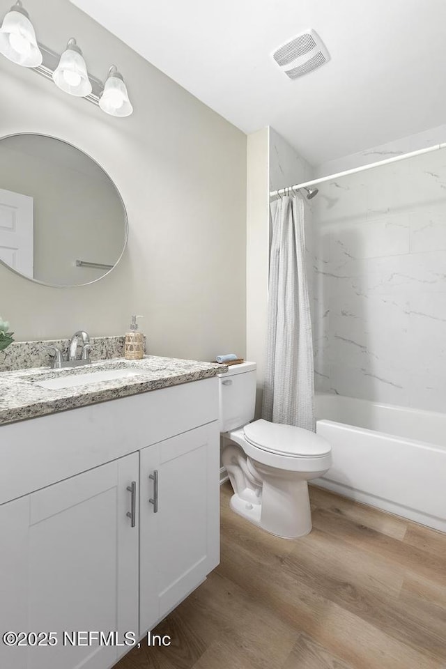 889 Aiken St, Saint Augustine, FL 32084 - bathroom with vanity, wood finished floors, toilet, and shower / tub combo