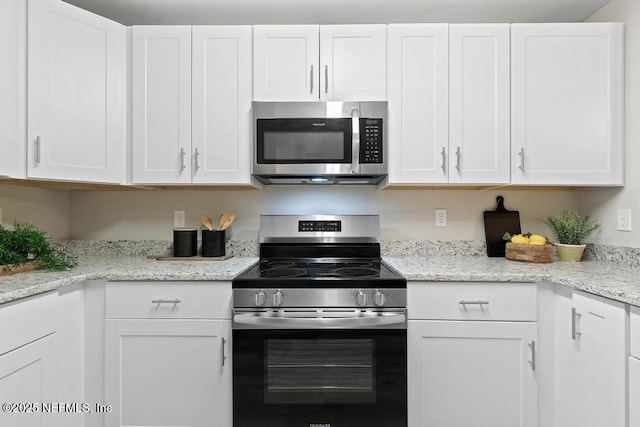 889 Aiken St, Saint Augustine, FL 32084 - kitchen with appliances with stainless steel finishes, white cabinets, and light stone counters