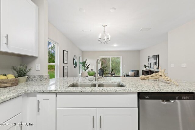 889 Aiken St, Saint Augustine, FL 32084 - kitchen with stainless steel dishwasher, a sink, white cabinets, and healthy amount of natural light