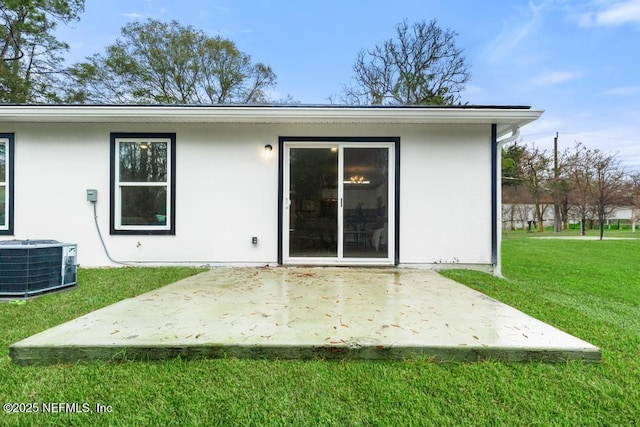 889 Aiken St, Saint Augustine, FL 32084 - back of house with cooling unit, a patio area, a lawn, and stucco siding