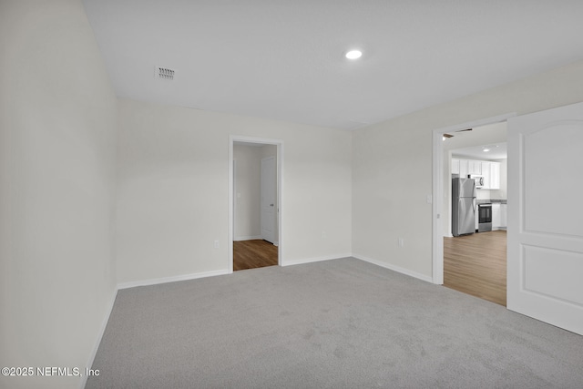 37330 Whisper Way, Hilliard, FL 32046 - unfurnished bedroom with freestanding refrigerator, carpet floors, baseboards, and recessed lighting