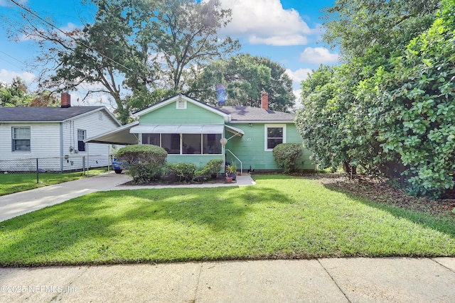 1131 Wycoff Ave, Jacksonville, FL 32205 - view of front facade featuring concrete driveway, a chimney, roof with shingles, and an attached carport