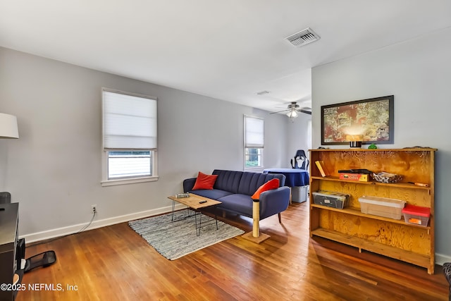 1131 Wycoff Ave, Jacksonville, FL 32205 - living room with wood finished floors, ceiling fan, and baseboards
