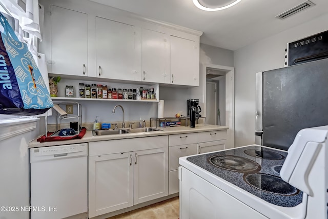 1131 Wycoff Ave, Jacksonville, FL 32205 - kitchen featuring white dishwasher, stove, a sink, white cabinets, and open shelves