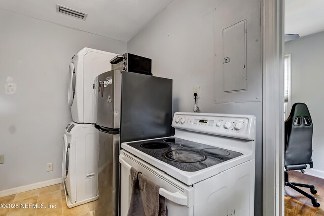1131 Wycoff Ave, Jacksonville, FL 32205 - kitchen with white electric range oven, electric panel, stacked washing machine and dryer, and baseboards