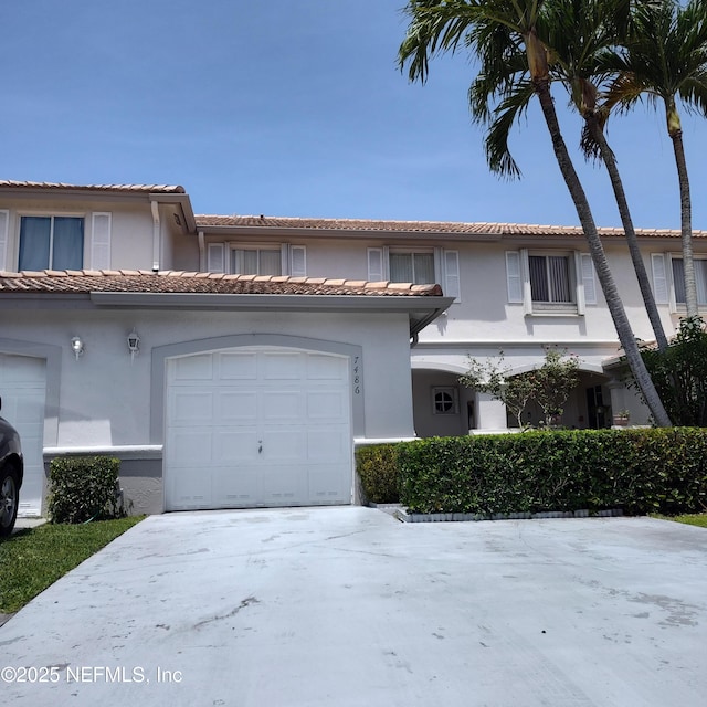 7486 SW 162nd Ct E, Miami, FL 33193 - view of front of property featuring stucco siding, a tile roof, and concrete driveway
