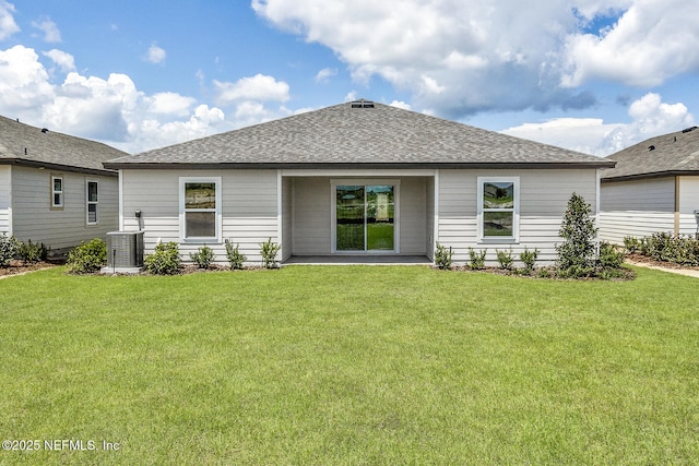 37132 Whippoorwill Ct, Hilliard, FL 32046 - back of house featuring a lawn, roof with shingles, and central AC