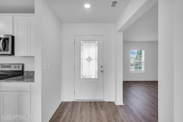 37132 Whippoorwill Ct, Hilliard, FL 32046 - foyer entrance featuring wood finished floors, baseboards, and recessed lighting
