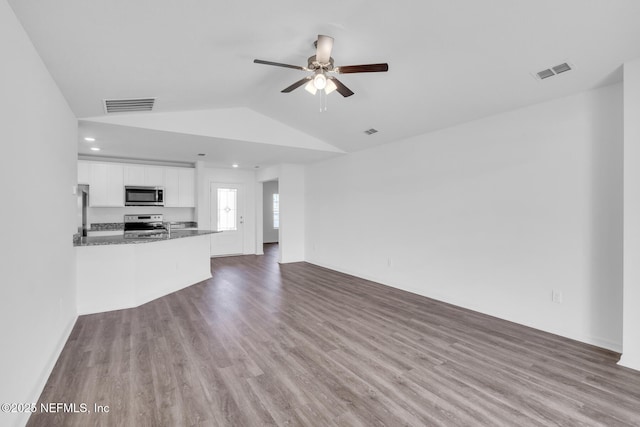 37132 Whippoorwill Ct, Hilliard, FL 32046 - unfurnished living room featuring wood finished floors, ceiling fan, vaulted ceiling, and recessed lighting