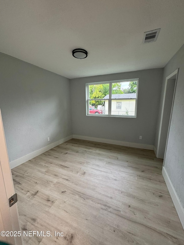 1413 W 21st St, Jacksonville, FL 32209 - unfurnished room with light wood-style flooring and baseboards