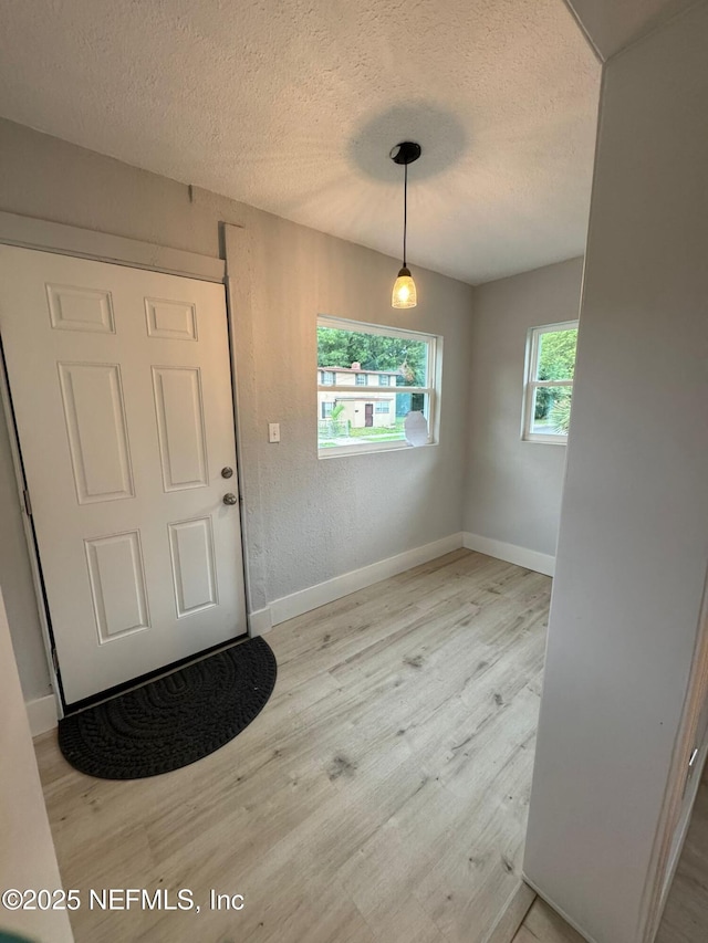 1413 W 21st St, Jacksonville, FL 32209 - foyer with wood finished floors, a textured ceiling, and baseboards