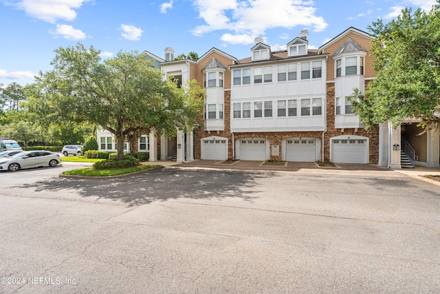 8550 Touchton Rd Unit 122, Jacksonville, FL 32216 - townhome / multi-family property with a garage and stone siding