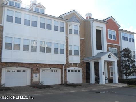8550 Touchton Rd Unit 122, Jacksonville, FL 32216 - view of building exterior featuring an attached garage