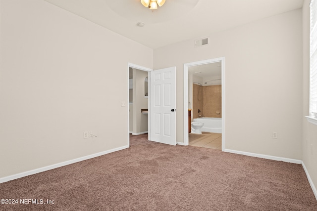 8550 Touchton Rd Unit 122, Jacksonville, FL 32216 - unfurnished bedroom with carpet, connected bathroom, and baseboards