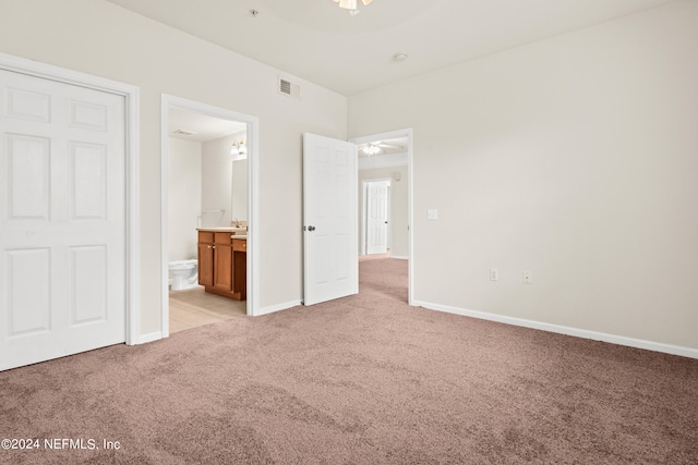 8550 Touchton Rd Unit 122, Jacksonville, FL 32216 - unfurnished bedroom featuring light colored carpet, baseboards, and connected bathroom