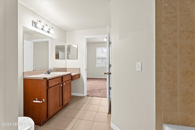 8550 Touchton Rd Unit 122, Jacksonville, FL 32216 - bathroom featuring vanity, tile patterned floors, toilet, baseboards, and a textured ceiling