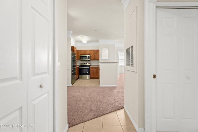 8550 Touchton Rd Unit 122, Jacksonville, FL 32216 - hallway with light carpet, light tile patterned flooring, ornamental molding, and baseboards
