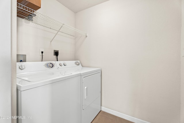 8550 Touchton Rd Unit 122, Jacksonville, FL 32216 - washroom featuring washer and clothes dryer, light tile patterned flooring, and baseboards