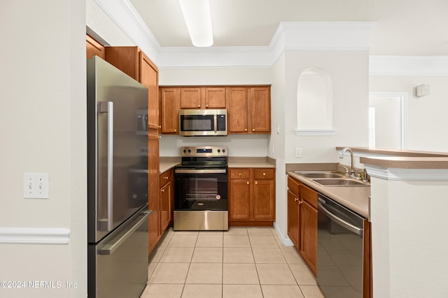8550 Touchton Rd Unit 122, Jacksonville, FL 32216 - kitchen featuring appliances with stainless steel finishes, crown molding, a sink, brown cabinetry, and light tile patterned floors