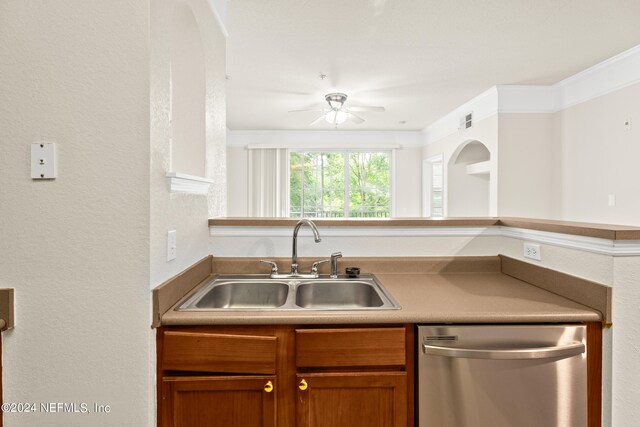 8550 Touchton Rd Unit 122, Jacksonville, FL 32216 - kitchen with stainless steel dishwasher, a sink, ceiling fan, brown cabinetry, and a textured wall