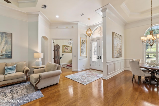 2435 Den St, Saint Augustine, FL 32092 - entrance foyer with a chandelier, arched walkways, wood finished floors, ornamental molding, and a towering ceiling