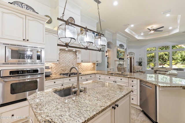 2435 Den St, Saint Augustine, FL 32092 - kitchen featuring stainless steel appliances, a sink, a ceiling fan, a peninsula, and crown molding