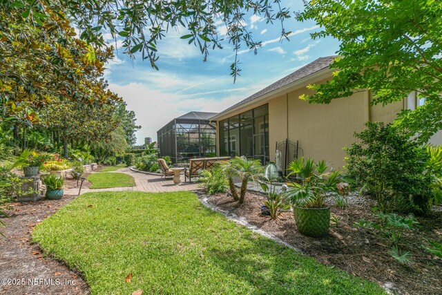 2435 Den St, Saint Augustine, FL 32092 - view of green lawn with a patio area and glass enclosure