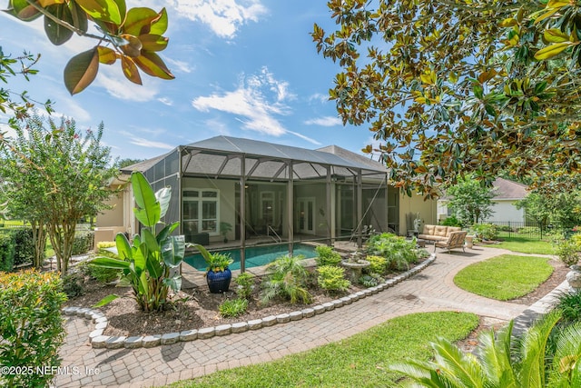 2435 Den St, Saint Augustine, FL 32092 - rear view of property featuring an outdoor living space, a patio area, an outdoor pool, stucco siding, and a lanai