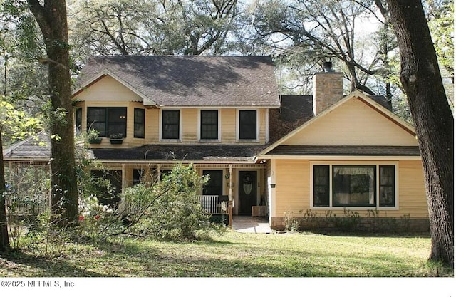 4714 SW 170th St, Archer, FL 32618 - view of front of home featuring a front yard, a chimney, a porch, and roof with shingles
