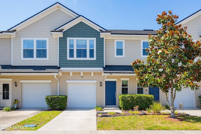 246 Moultrie Village Ln, Saint Augustine, FL 32086 - townhome / multi-family property with roof with shingles, a garage, concrete driveway, and stucco siding