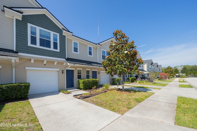 246 Moultrie Village Ln, Saint Augustine, FL 32086 - townhome / multi-family property featuring a garage, driveway, a residential view, and a front lawn