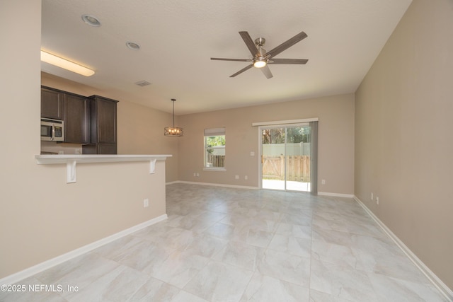 246 Moultrie Village Ln, Saint Augustine, FL 32086 - unfurnished living room with ceiling fan, a chandelier, and baseboards