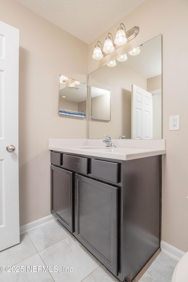 246 Moultrie Village Ln, Saint Augustine, FL 32086 - bathroom with vanity, baseboards, and tile patterned flooring