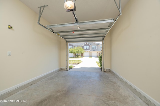 246 Moultrie Village Ln, Saint Augustine, FL 32086 - garage featuring a garage door opener and baseboards