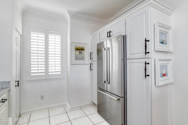 2315 Vista Cove Rd, Saint Augustine, FL 32084 - kitchen featuring high quality fridge, baseboards, white cabinets, crown molding, and light tile patterned floors