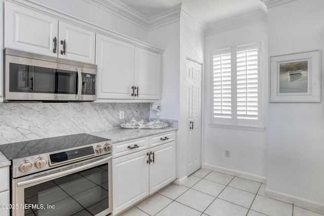 2315 Vista Cove Rd, Saint Augustine, FL 32084 - kitchen with stainless steel appliances, backsplash, white cabinetry, baseboards, and healthy amount of natural light