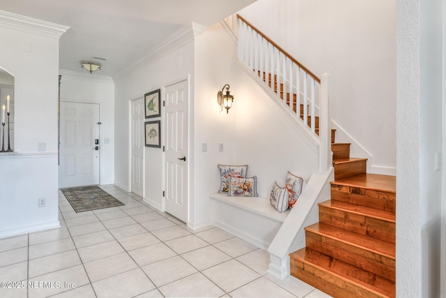 2315 Vista Cove Rd, Saint Augustine, FL 32084 - foyer featuring stairway, light tile patterned floors, ornamental molding, and arched walkways