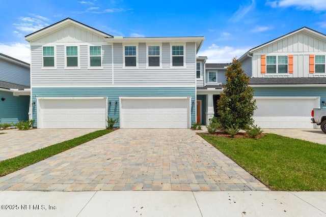 217 Silver Myrtle Ct, Saint Augustine, FL 32092 - view of front of house featuring board and batten siding, a garage, and decorative driveway