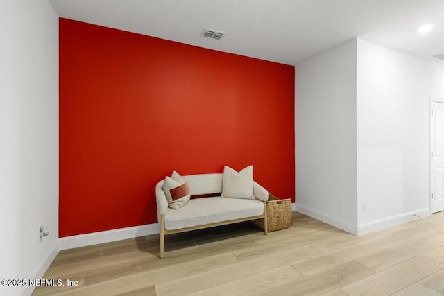 217 Silver Myrtle Ct, Saint Augustine, FL 32092 - sitting room featuring an accent wall, wood finished floors, baseboards, and recessed lighting