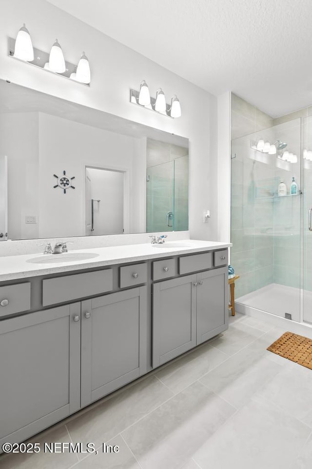 217 Silver Myrtle Ct, Saint Augustine, FL 32092 - full bath with a shower stall, double vanity, tile patterned floors, and a textured ceiling